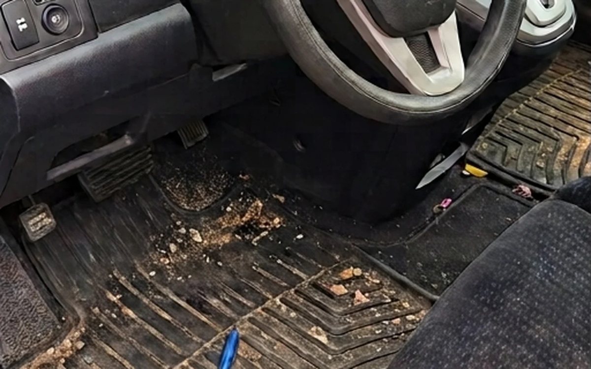 Before: a Honda driver footwell in Surrey with crumbs and debris across the floor mat